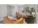 Bright living room featuring hardwood floors, modern furniture, and a large window at 23841 E Alabama Dr, Aurora, CO 80018