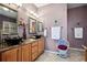 Stylish bathroom featuring double vessel sinks, granite counters, and decorative accents at 23545 E Phillips Pl, Aurora, CO 80016