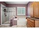 Bright bathroom with a soaking tub, glass-enclosed shower, and neutral tile at 23545 E Phillips Pl, Aurora, CO 80016