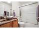 A well-lit bathroom with a modern vanity and a glass-enclosed shower and bathtub with neutral wall paint at 23545 E Phillips Pl, Aurora, CO 80016