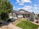 Charming home with a manicured front lawn, stone accents, and a welcoming front porch at 23545 E Phillips Pl, Aurora, CO 80016