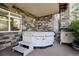 Inviting hot tub on the back patio with stone surround, providing a private and relaxing space at 23545 E Phillips Pl, Aurora, CO 80016