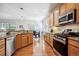 Bright kitchen with stainless steel appliances, wood floors, and breakfast nook with natural light at 23545 E Phillips Pl, Aurora, CO 80016