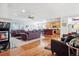 Spacious open-concept living area with fireplace, kitchen and hardwood flooring at 23545 E Phillips Pl, Aurora, CO 80016