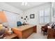 Bright office space featuring plantation shutters, neutral carpet and a large desk, perfect for remote work at 23545 E Phillips Pl, Aurora, CO 80016