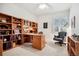 Home office featuring built-in bookshelves, a large desk, and an office chair at 23545 E Phillips Pl, Aurora, CO 80016