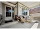Inviting porch seating area with wicker furniture and a view of the neighborhood at 23545 E Phillips Pl, Aurora, CO 80016