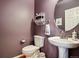 Charming powder room with pedestal sink, decorative mirror, and neutral paint at 23545 E Phillips Pl, Aurora, CO 80016