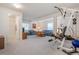 An open basement area with a gym and a living room, perfect for entertaining guests and fitness activities at 23545 E Phillips Pl, Aurora, CO 80016