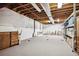Spacious unfinished basement with white walls and a storage cabinet, offering potential for customization at 23545 E Phillips Pl, Aurora, CO 80016
