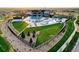 Aerial view of the community center featuring a pool, playground, and well-maintained green spaces at 27655 E Geddes Pl, Aurora, CO 80016