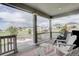 Cozy covered back porch with comfortable seating and a view of the community at 27655 E Geddes Pl, Aurora, CO 80016