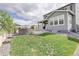 Backyard with green lawn, stone seating area, and landscaped features at 27655 E Geddes Pl, Aurora, CO 80016