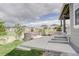 Backyard featuring a stone seating area, fire pit, and view of neighboring homes at 27655 E Geddes Pl, Aurora, CO 80016