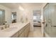 Bright bathroom with a double sink vanity, walk-in shower, and tiled floors at 27655 E Geddes Pl, Aurora, CO 80016