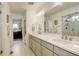 Bright bathroom with a double sink vanity, white cabinets, and tiled floors at 27655 E Geddes Pl, Aurora, CO 80016