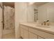 Bathroom featuring white cabinets, a vanity and a shower with patterned curtain at 27655 E Geddes Pl, Aurora, CO 80016