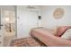 Bedroom featuring a pink quilt, a sunny window, and access to the stairway at 27655 E Geddes Pl, Aurora, CO 80016