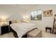 Bright bedroom featuring a large window with mountain views and stylish decor at 27655 E Geddes Pl, Aurora, CO 80016