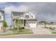 Charming two-story home featuring a two car garage, inviting porch, and manicured front yard at 27655 E Geddes Pl, Aurora, CO 80016