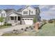 Charming two-story home with a two car garage, inviting porch, and beautifully landscaped front yard at 27655 E Geddes Pl, Aurora, CO 80016