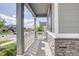 Inviting covered porch with stone accents and a white picket fence, perfect for relaxing outdoors at 27655 E Geddes Pl, Aurora, CO 80016