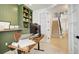 Cozy home office with custom green built-ins and a view of the modern staircase and entryway at 27655 E Geddes Pl, Aurora, CO 80016
