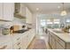 Bright, modern kitchen features white cabinets, stainless steel appliances, and an adjacent dining area at 27655 E Geddes Pl, Aurora, CO 80016