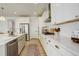 Contemporary kitchen with stainless steel appliances, stylish cabinets, and an elegant, decorative rug at 27655 E Geddes Pl, Aurora, CO 80016