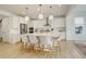 Bright, modern kitchen with stainless steel appliances, a spacious island with seating, and white cabinetry at 27655 E Geddes Pl, Aurora, CO 80016