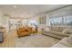 Open-concept living room connected to a modern kitchen and dining area, perfect for entertaining at 27655 E Geddes Pl, Aurora, CO 80016