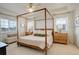 Main bedroom featuring a four-poster bed, natural lighting, and views of the surrounding neighborhood at 27655 E Geddes Pl, Aurora, CO 80016