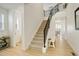 Bright and open staircase with modern railings, leading to the upper level of the home at 27655 E Geddes Pl, Aurora, CO 80016