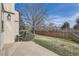 Fenced backyard with grass and trees, providing a private outdoor space at 11981 E Yale Ave, Aurora, CO 80014