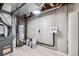 Basement mechanical room with water heater, furnace, plumbing, and concrete walls at 11981 E Yale Ave, Aurora, CO 80014