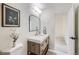 Modern bathroom with a stylish vanity, framed mirror, and decorative vase at 11981 E Yale Ave, Aurora, CO 80014
