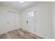 Clean, bright entryway featuring wood-look flooring, a white front door, and a closet with sliding doors at 11981 E Yale Ave, Aurora, CO 80014