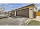 Garage with brown doors and asphalt driveway at 11981 E Yale Ave, Aurora, CO 80014