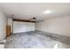 Spacious two car garage with a modern door and visible concrete floor at 11981 E Yale Ave, Aurora, CO 80014