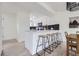 Modern kitchen with breakfast bar, stainless steel appliances and dark backsplash at 11981 E Yale Ave, Aurora, CO 80014