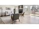 Bright living room with light wood floors, fireplace, neutral furnishings, and large windows at 11981 E Yale Ave, Aurora, CO 80014