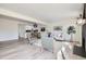 An open-concept living space featuring a fireplace and flows into the dining area and kitchen at 11981 E Yale Ave, Aurora, CO 80014
