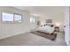 Bright main bedroom with carpet, two windows, and neutral decor at 11981 E Yale Ave, Aurora, CO 80014