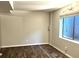 Finished basement with wood floors and a window allowing light in at 1470 S Quebec Way # 275, Denver, CO 80231