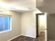A simple bedroom with a window and hardwood floors that leads to an open closet at 1470 S Quebec Way # 275, Denver, CO 80231