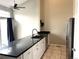 Modern kitchen featuring stainless steel appliances, stone counters, and white cabinets at 1470 S Quebec Way # 275, Denver, CO 80231