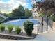 Seasonal pool with cover surrounded by well-maintained landscaping adding beauty and privacy at 1470 S Quebec Way # 275, Denver, CO 80231