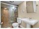 Bathroom with glass shower, pedestal sink, and tile flooring at 777 N Washington St # 204, Denver, CO 80203