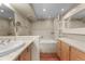 Bathroom with a tub, neutral tile, a modern sink, and wood-style floors at 777 N Washington St # 204, Denver, CO 80203