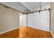 Bedroom with hardwood floors, sliding closet doors, and ample space at 777 N Washington St # 204, Denver, CO 80203